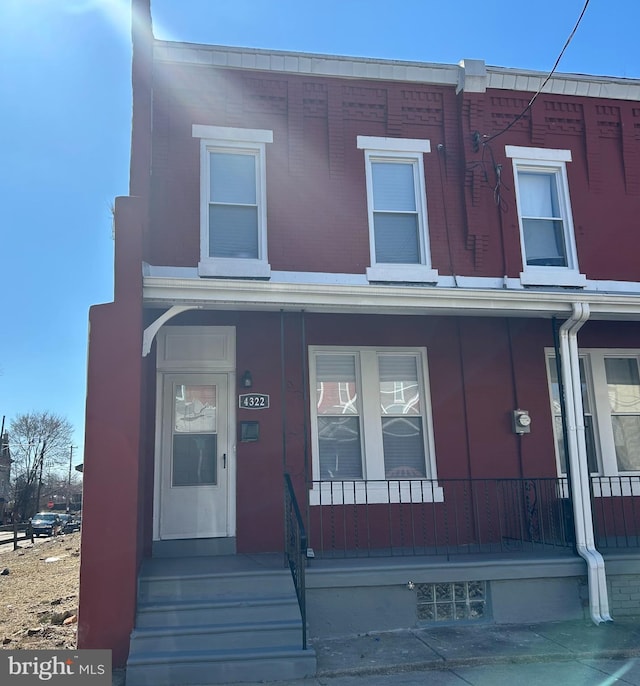 multi unit property with covered porch and brick siding