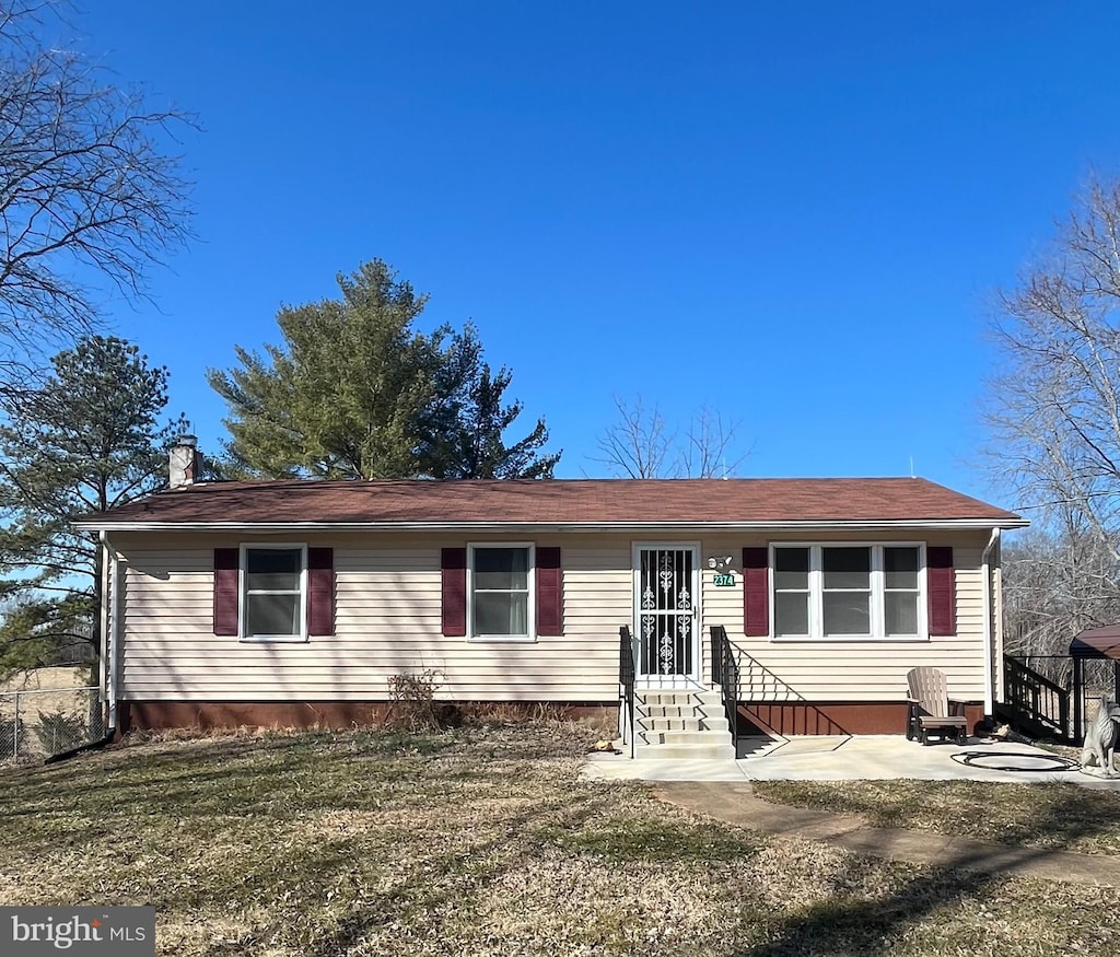 single story home with entry steps and a chimney