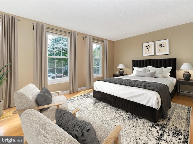 bedroom featuring light wood-type flooring and baseboards