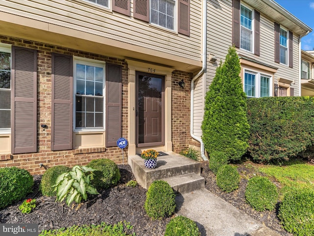 property entrance with brick siding