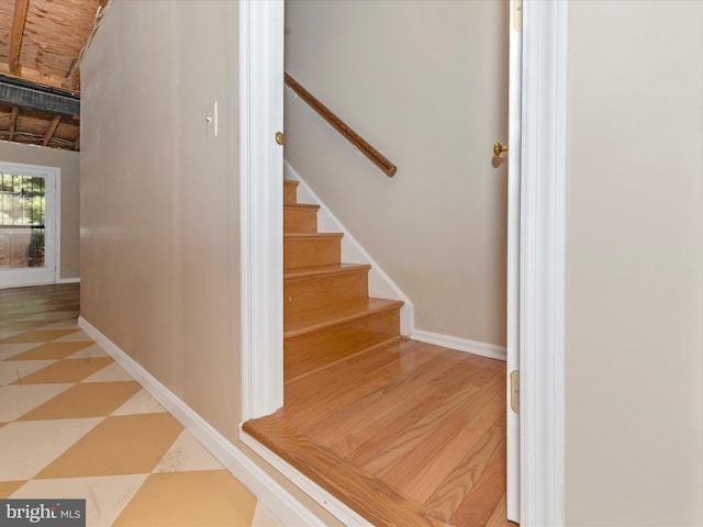 stairs featuring baseboards and tile patterned floors