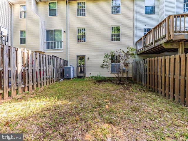 back of house featuring central air condition unit and a fenced backyard