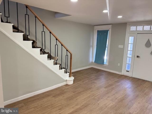 entryway featuring stairs, baseboards, wood finished floors, and recessed lighting