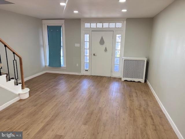 entryway with stairway, recessed lighting, wood finished floors, and baseboards