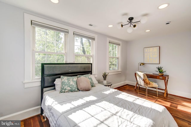 bedroom featuring recessed lighting, visible vents, baseboards, and wood finished floors