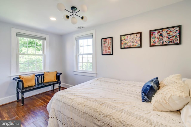 bedroom featuring dark wood-style flooring, visible vents, and baseboards