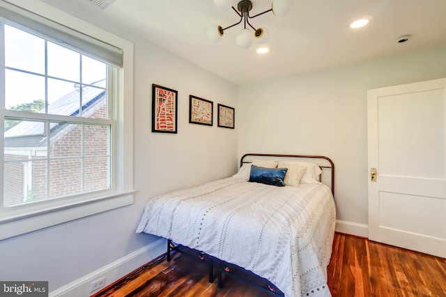 bedroom with baseboards, wood finished floors, and recessed lighting