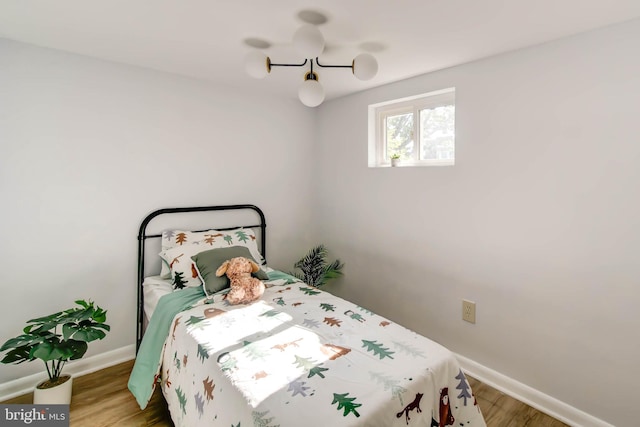 bedroom featuring baseboards and wood finished floors