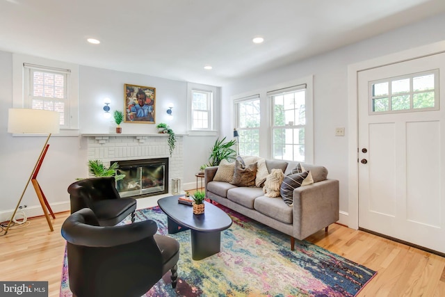 living room with baseboards, a fireplace, wood finished floors, and recessed lighting