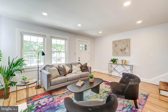 living area with recessed lighting, baseboards, and wood finished floors