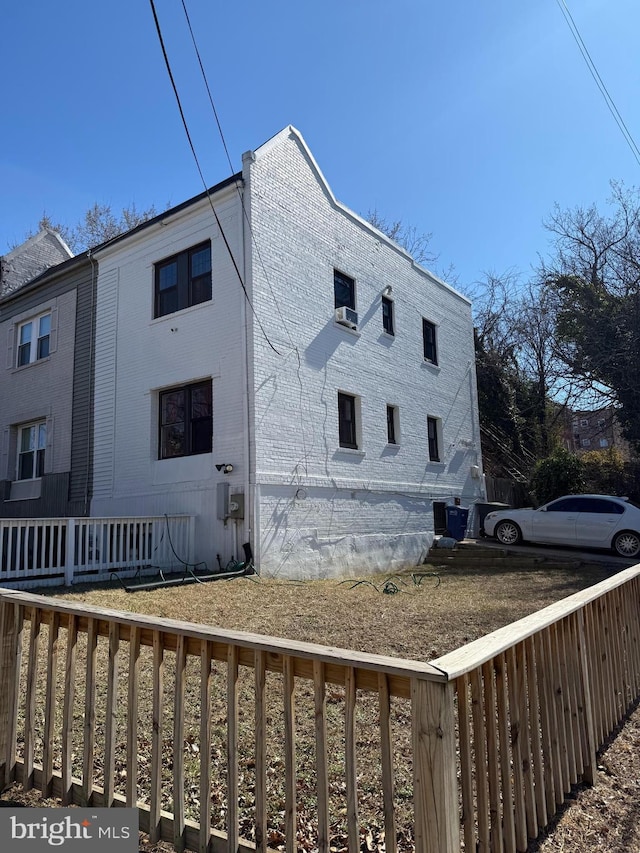 view of side of property featuring brick siding