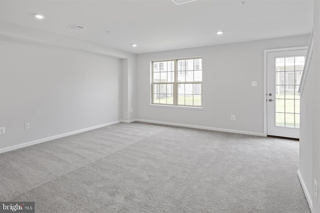 spare room with recessed lighting, a wealth of natural light, and carpet flooring