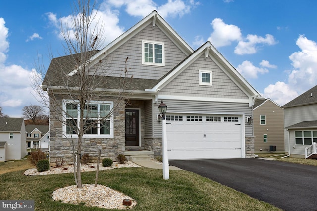 craftsman inspired home with aphalt driveway, stone siding, and roof with shingles