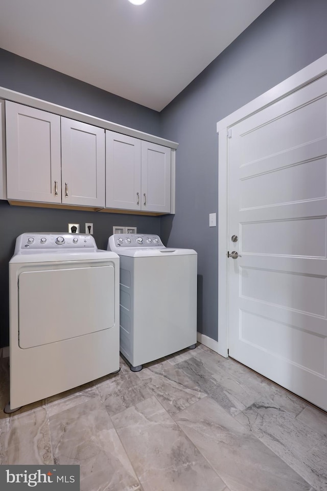 laundry room with washer and dryer, cabinet space, marble finish floor, and baseboards