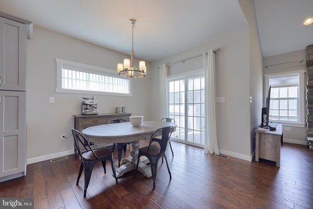 dining room with visible vents, a notable chandelier, dark wood-style floors, and baseboards