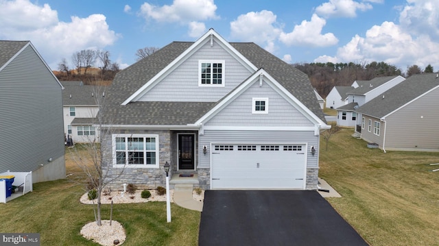 craftsman-style house with stone siding, driveway, a front lawn, and roof with shingles