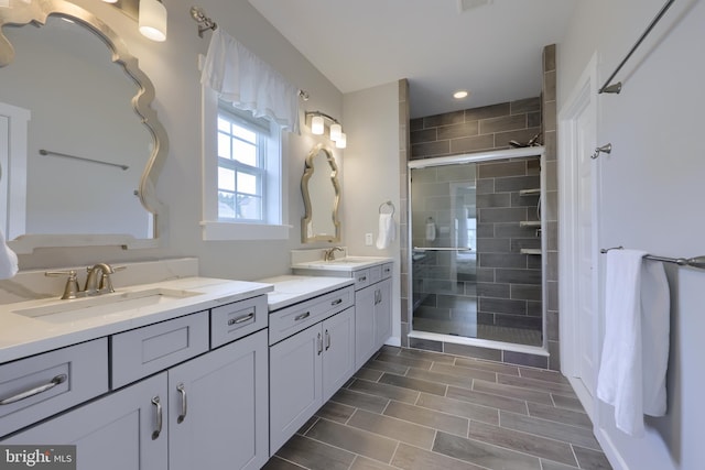 bathroom with vanity, visible vents, and a stall shower