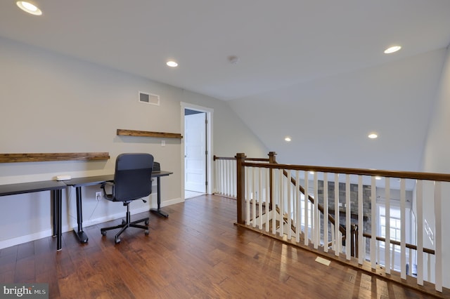 office space with visible vents, recessed lighting, baseboards, wood-type flooring, and lofted ceiling