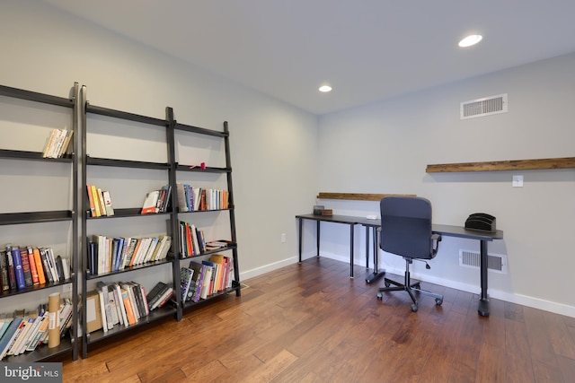 office area featuring wood finished floors, visible vents, and baseboards