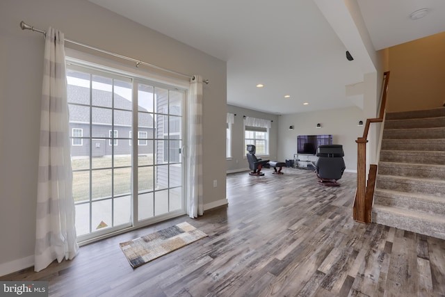 interior space with stairway, baseboards, and wood finished floors