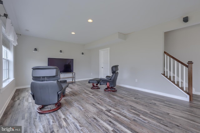 living room with stairs, recessed lighting, wood finished floors, and baseboards