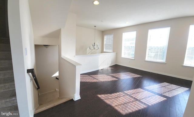 interior space featuring an inviting chandelier, baseboards, wood finished floors, and recessed lighting