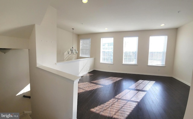 empty room with baseboards, dark wood-style flooring, recessed lighting, and a healthy amount of sunlight