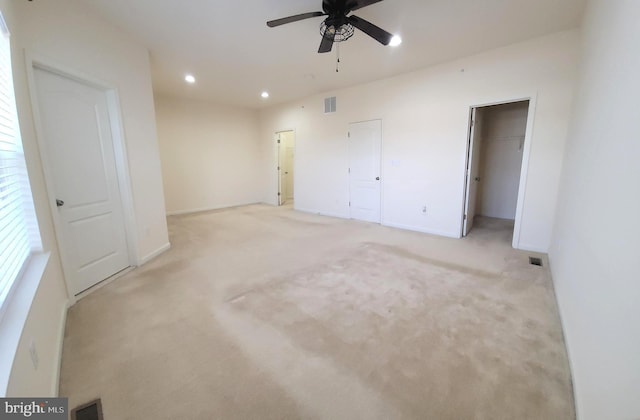 unfurnished bedroom featuring recessed lighting, visible vents, and light colored carpet