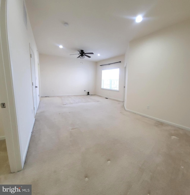 empty room with light carpet, ceiling fan, baseboards, and recessed lighting