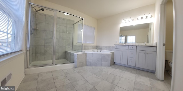 full bathroom with visible vents, toilet, a garden tub, vanity, and a shower stall