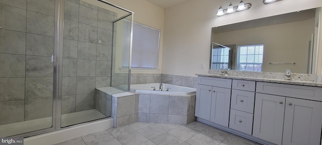 bathroom with a sink, double vanity, a shower stall, and a bath