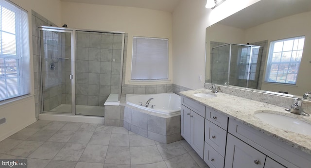 bathroom featuring a stall shower, a sink, and a bath