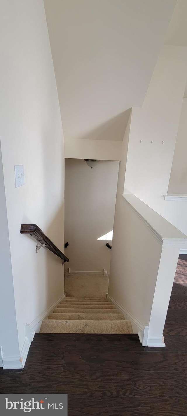 stairs with baseboards and wood finished floors