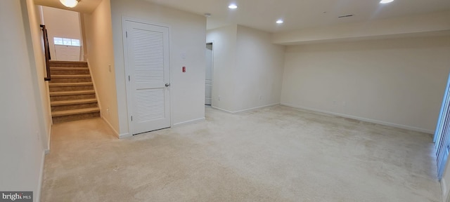 finished below grade area featuring carpet floors, baseboards, stairway, and recessed lighting