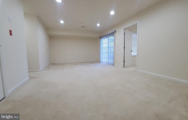 carpeted spare room featuring baseboards and recessed lighting