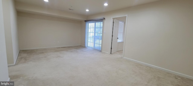 carpeted empty room featuring baseboards and recessed lighting