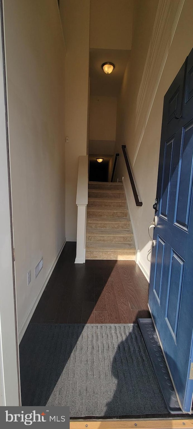 stairway featuring tile patterned flooring and baseboards