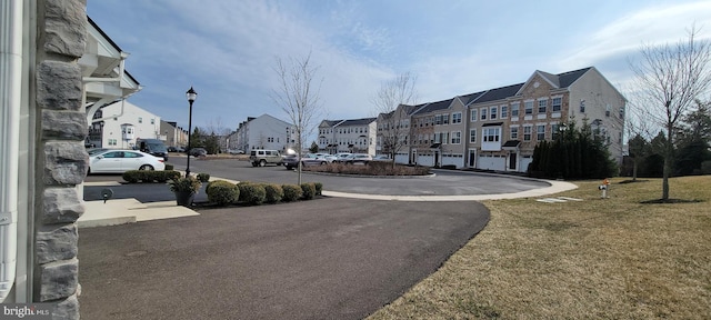 view of road with a residential view and street lights