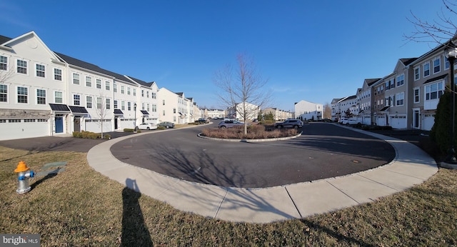 view of street featuring a residential view, curbs, and sidewalks