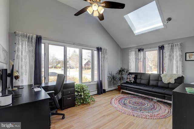 office featuring a baseboard heating unit, a healthy amount of sunlight, and light wood-style flooring