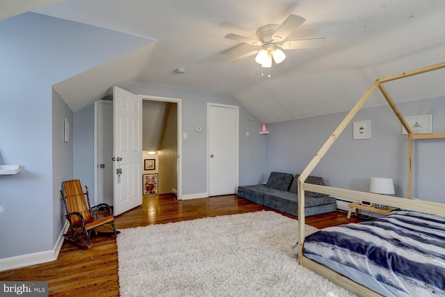 bedroom with ceiling fan, baseboards, vaulted ceiling, and wood finished floors