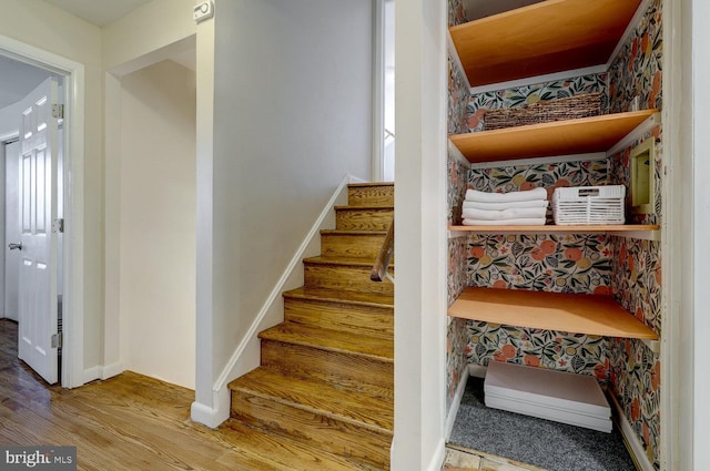 stairs with baseboards and wood finished floors