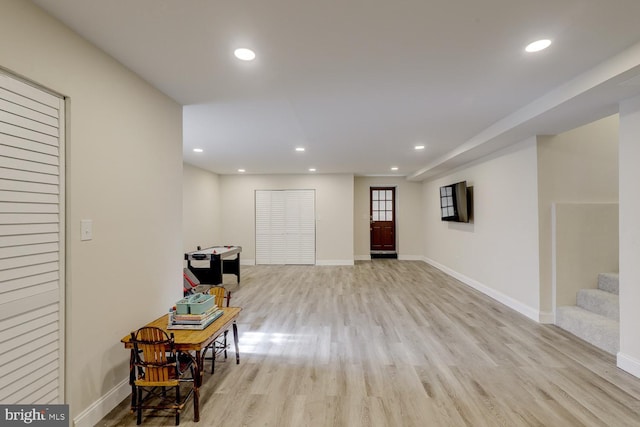 interior space featuring light wood finished floors, stairs, baseboards, and recessed lighting