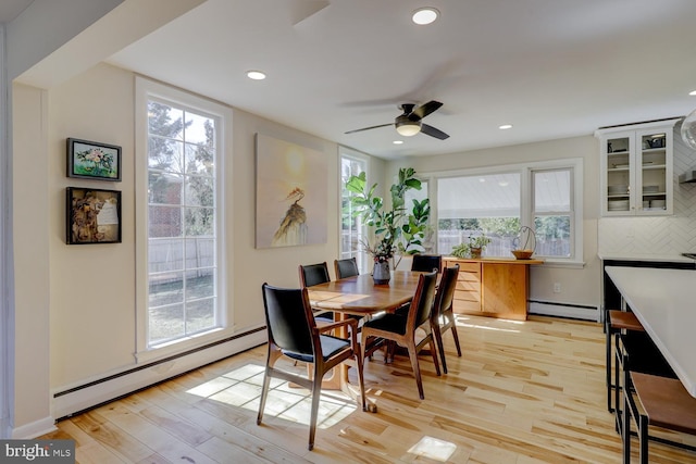 dining room featuring a baseboard heating unit, recessed lighting, and light wood-style floors