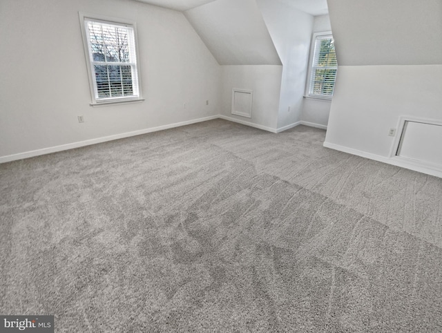 bonus room with carpet, lofted ceiling, and baseboards