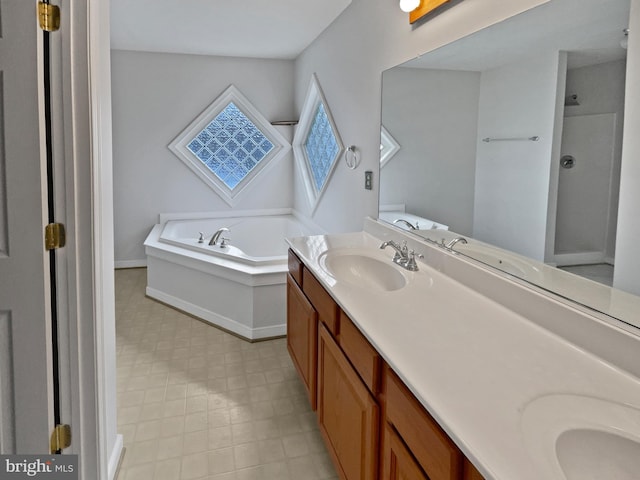 bathroom with double vanity, baseboards, a garden tub, walk in shower, and a sink