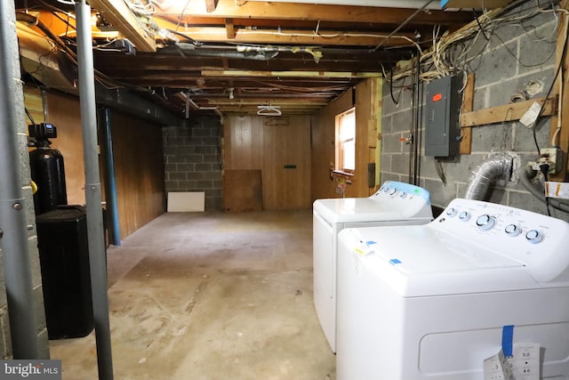 basement featuring washing machine and dryer and electric panel