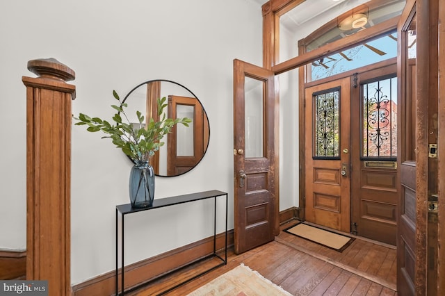 foyer entrance with french doors, baseboards, and hardwood / wood-style flooring