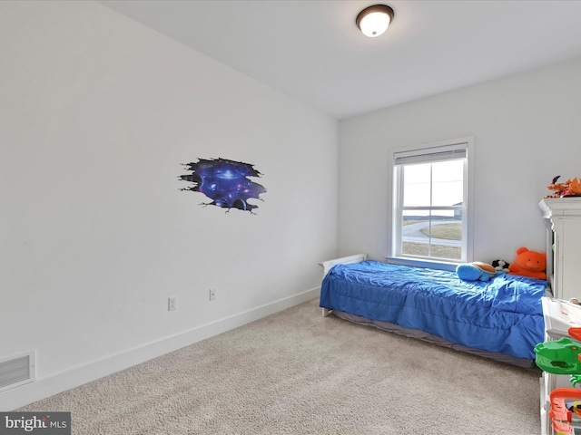 carpeted bedroom featuring baseboards and visible vents