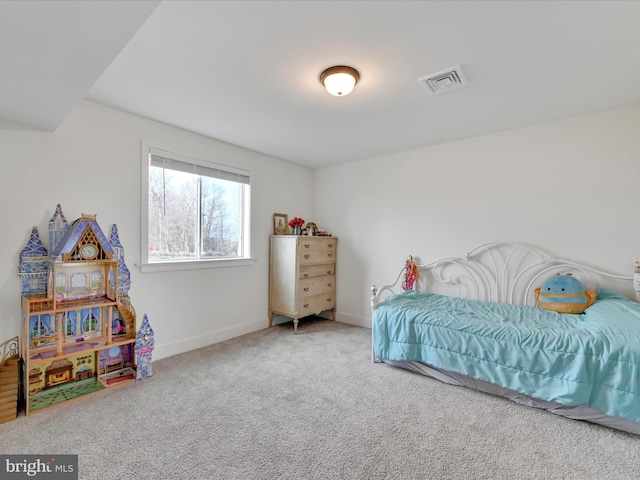 carpeted bedroom with visible vents and baseboards